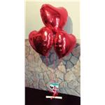 tris di palloncini a cuore con pergamena